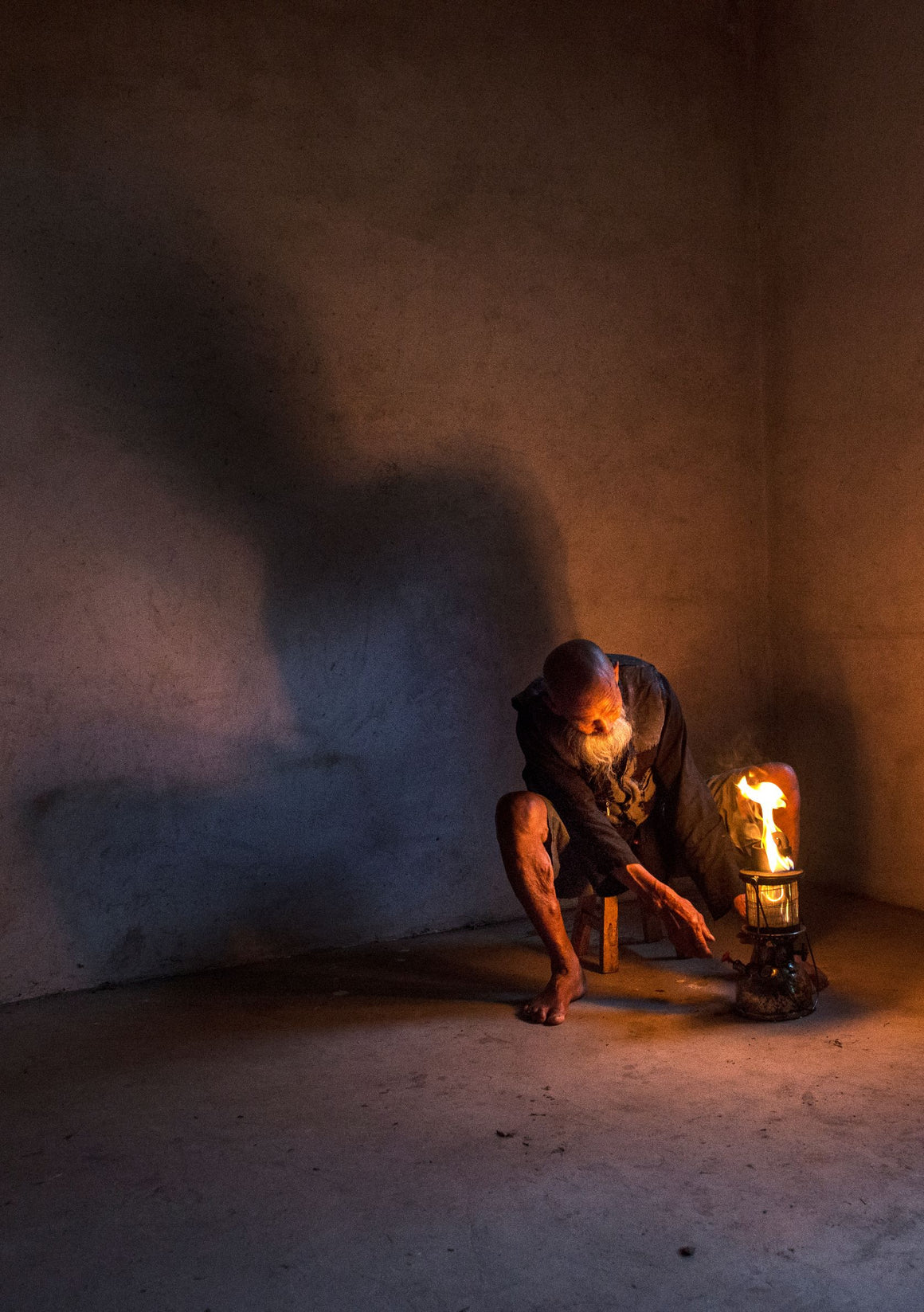 Cormorant fisherman with oil lamp drawing his silhouette